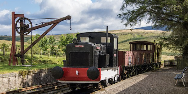 Converted station house with railway engine and
            waggons